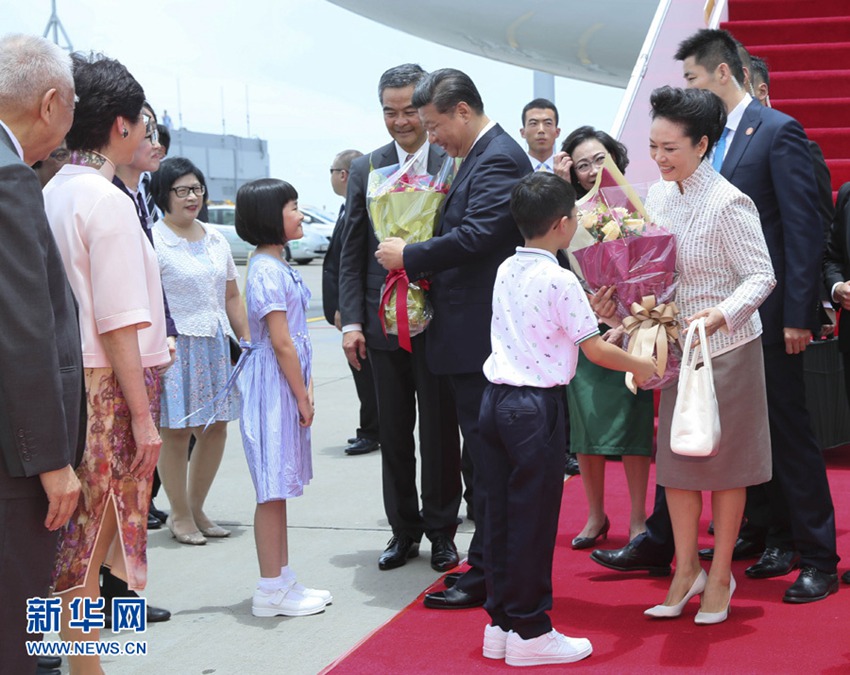 這是習近平和夫人彭麗媛在舷梯旁接受兩名香港少年敬獻鮮花。新華社記者 蘭紅光 攝